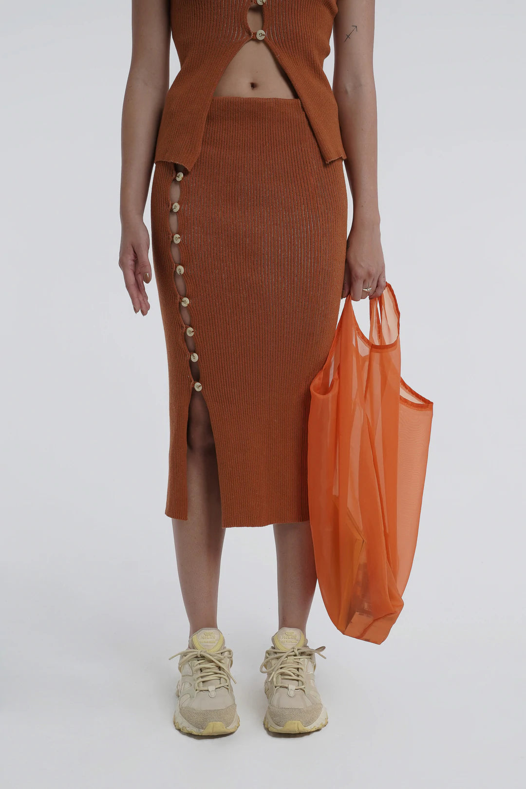 Kick up skirt in tobacco with button side detail.