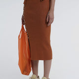 Kick up skirt in tobacco with button side detail.
