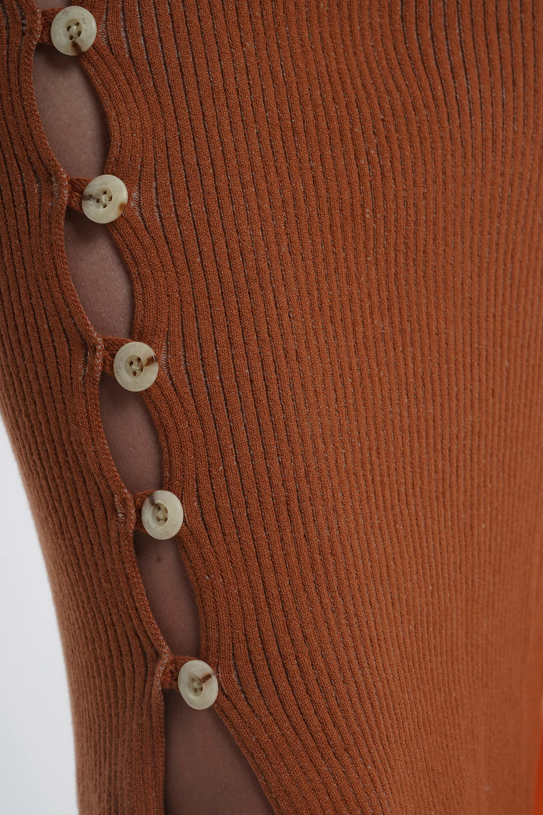 Kick up skirt in tobacco with button side detail.