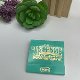 A pack of teal incense matches placed on a white table. 