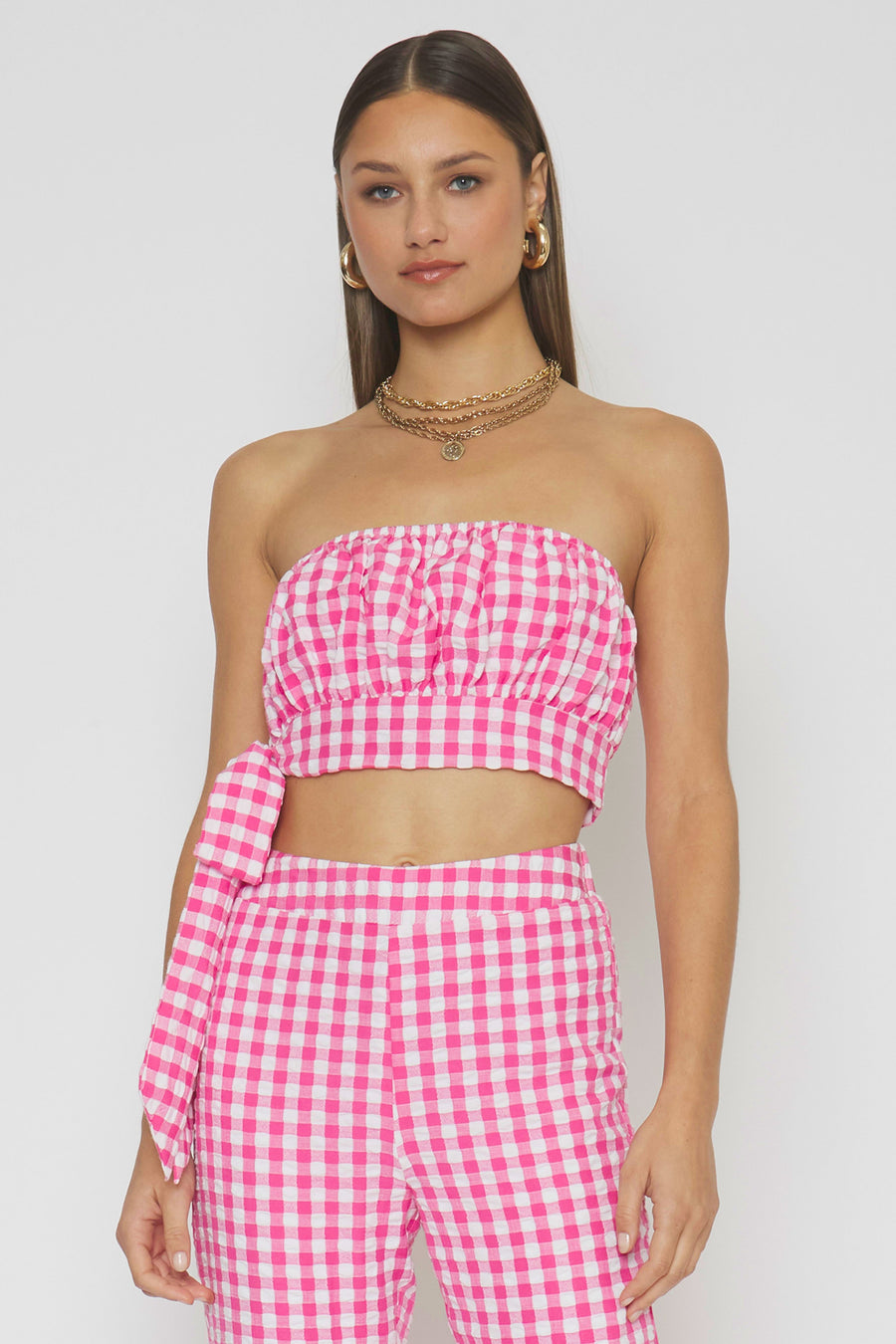 woman wearing pink gingham top