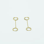 this image depicts gold hoop earrings studded with diamonds on a chain