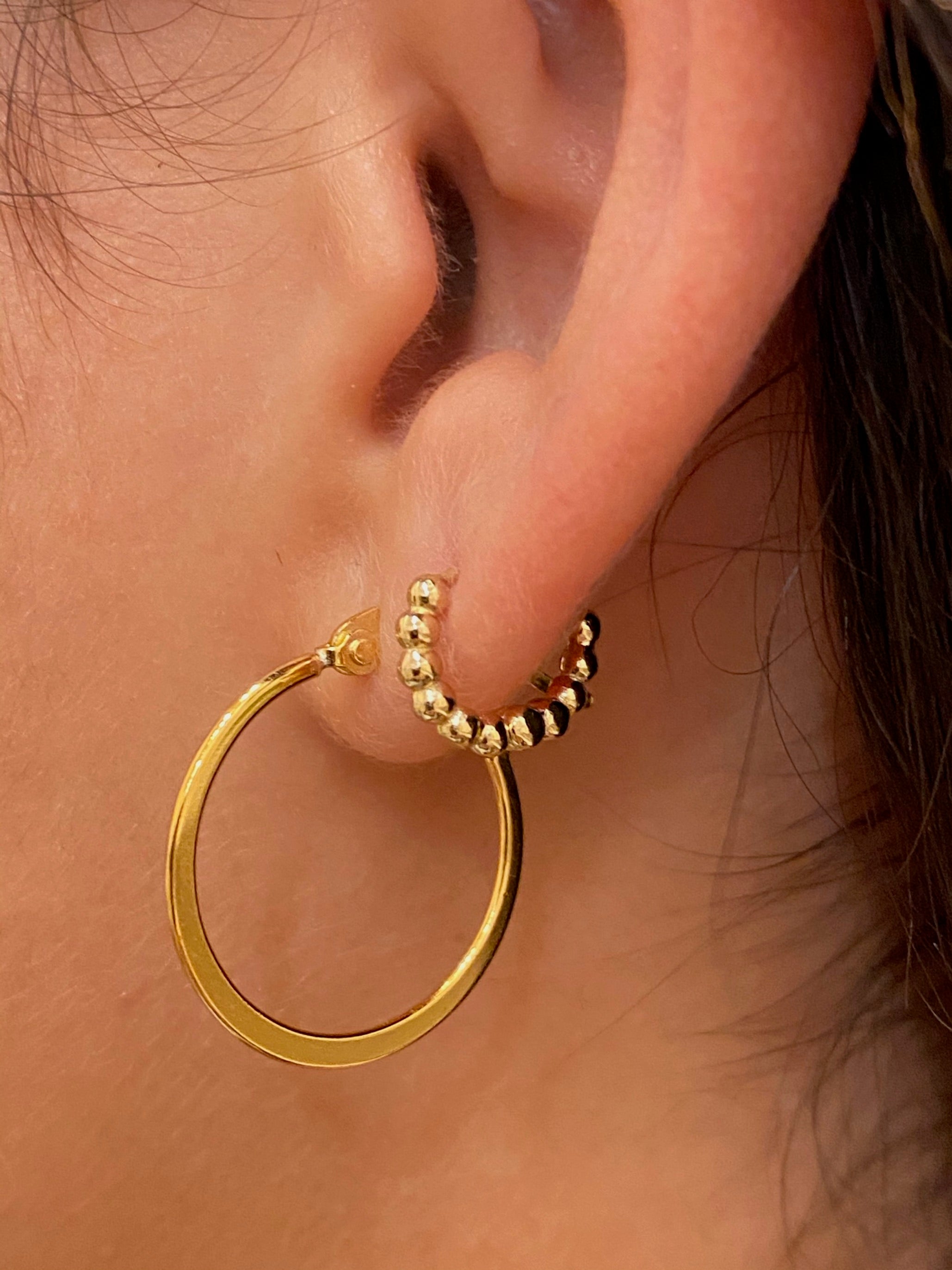 huggie earrings on model 