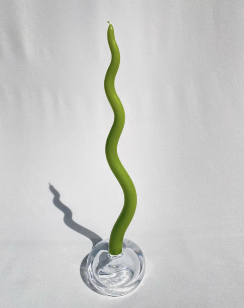 candle stick placed in spherical holder against white backdrop
