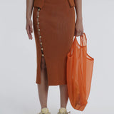 Kick up skirt in tobacco with button side detail.