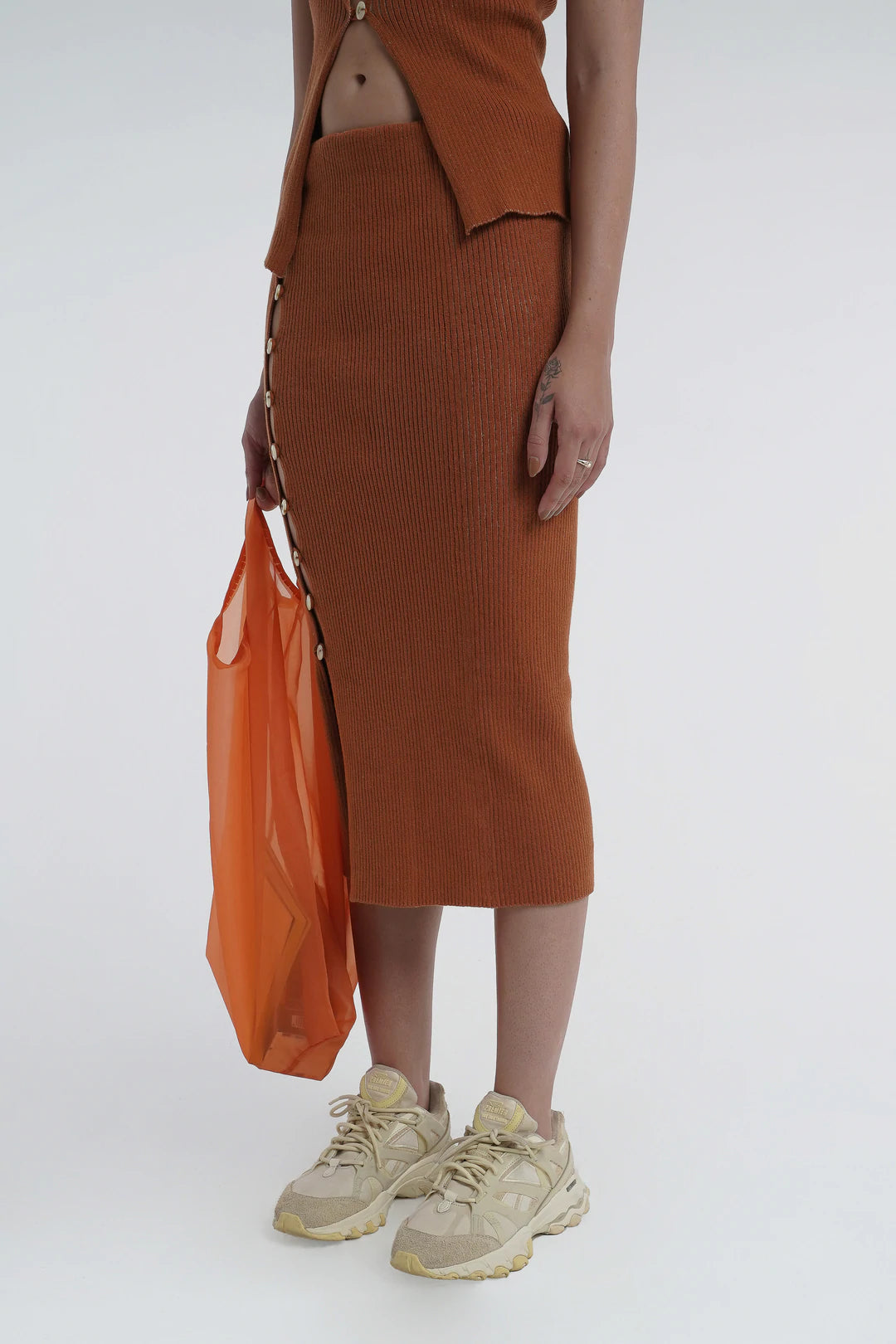 Kick up skirt in tobacco with button side detail.